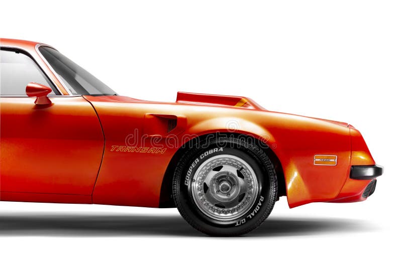 Orange colored Side front view of a 1974 Pontiac Trans Am Brand muscle car on a white background studio shot