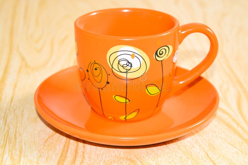 Orange Cup on a saucer stock photo. Image of crockery 91658948