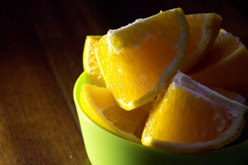 Orange cut into quarters stock photo. Image of lemons 90129456