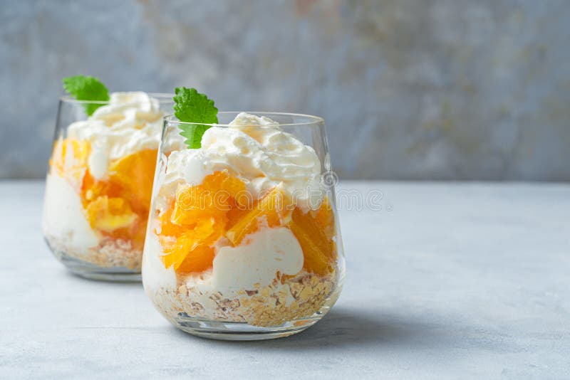 Orange Dessert with Cream and Mint. Two Servings of Fruit Dessert Stock