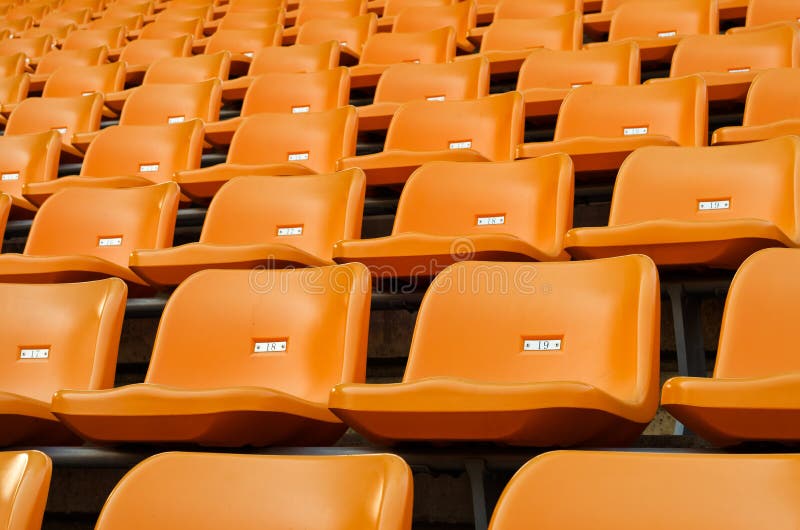 Orange Empty plastic seats at stadium royalty free stock images