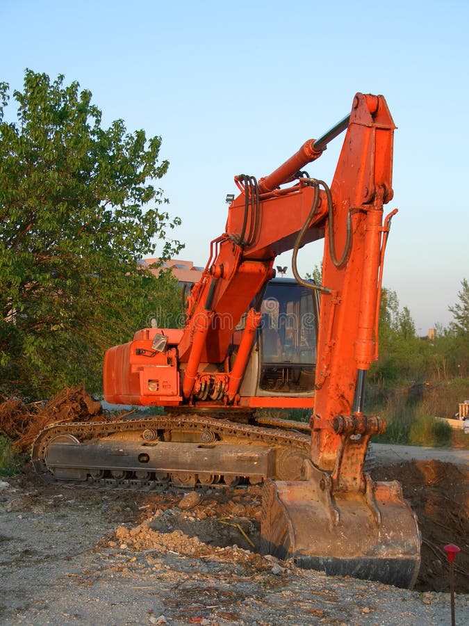 Orange wheeled excavator in a construction site. Track hoe construction excavator stock images, royalty-free photos and pictures