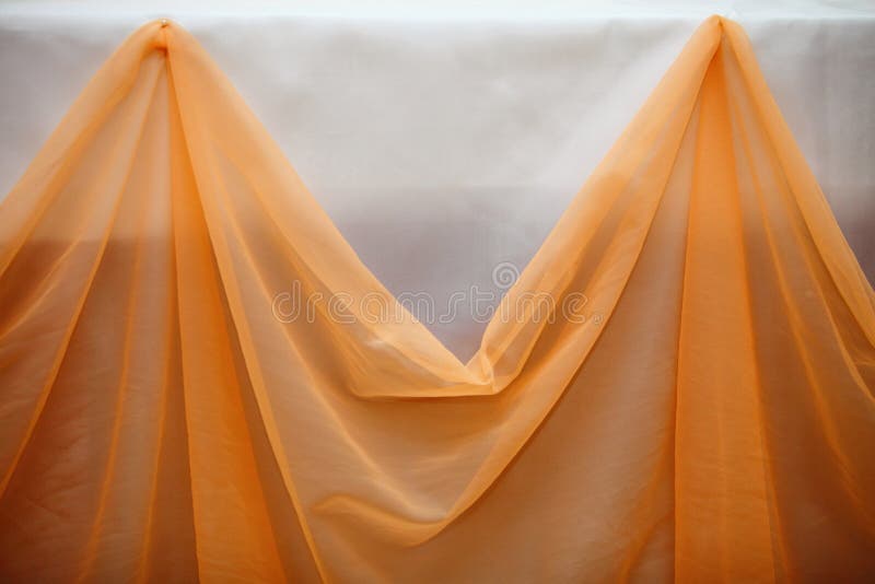Orange Fabric Cloth and White Wall Decor Detail Stock Photo