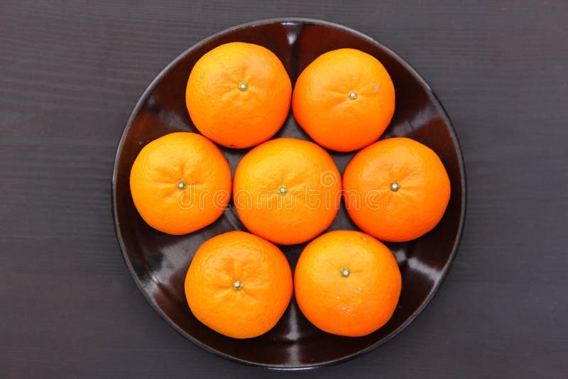 7 Orange Fruit Citrus Tankan on Black Dish Against Black Background Stock  Image - Image of seven, citrus: 148287603