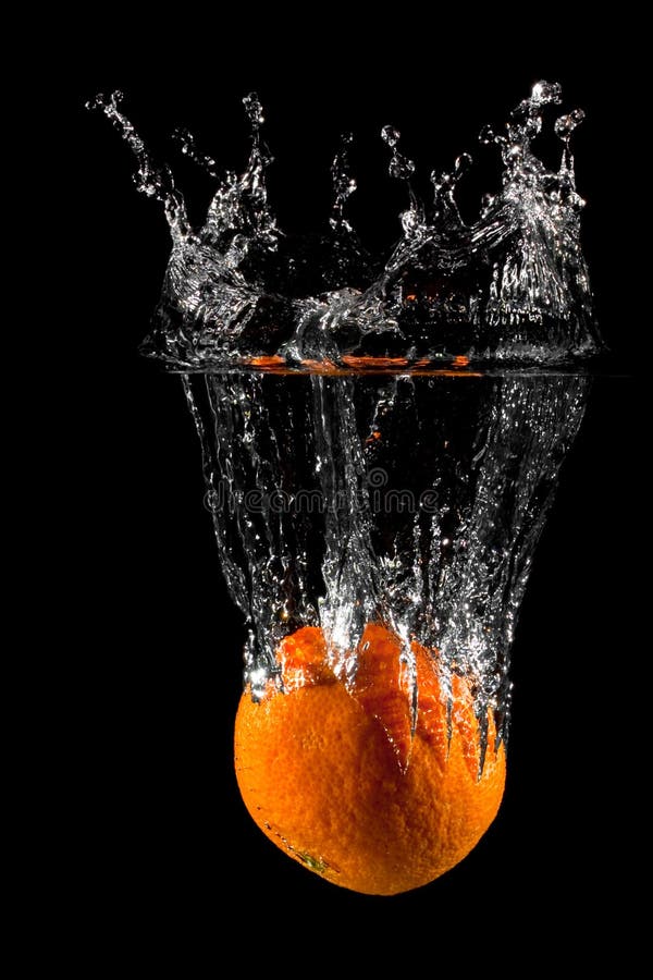 An Orange splashing into water on a black background. An Orange splashing into water on a black background.