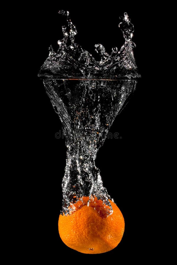 An Orange splashing into water on a black background. An Orange splashing into water on a black background.