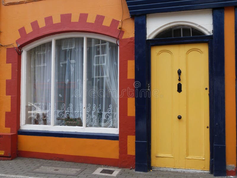 Orange House Facade and Yellow Front Door in Ireland Stock Image