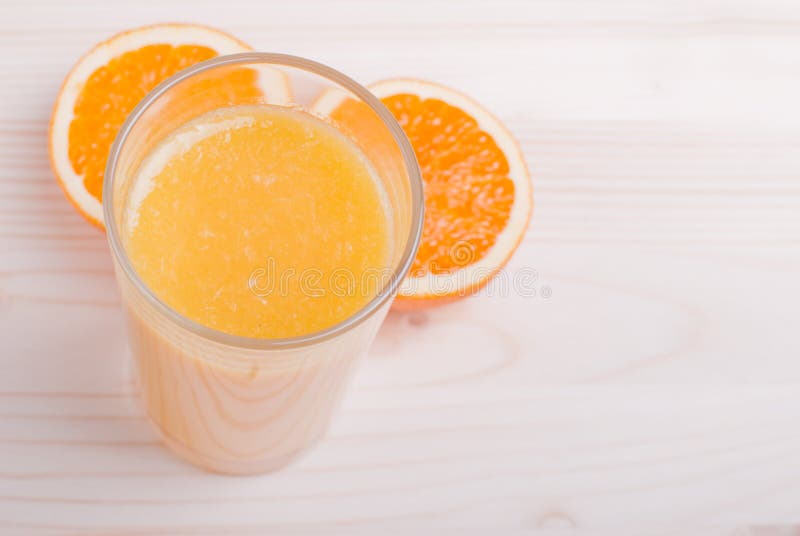Orange Juice beside Delicious Ripe Oranges on the Table Stock Photo