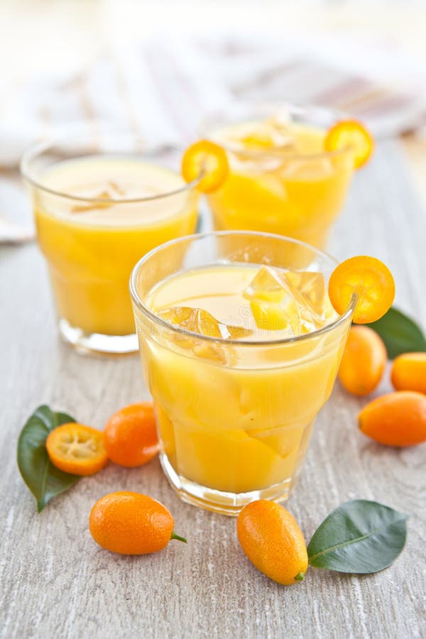 Orange juice and kumquats stock photo. Image of spoons 30319814