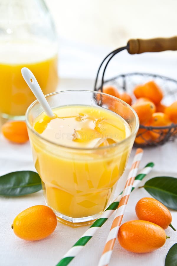 Orange juice and kumquats stock photo. Image of straws 30320050