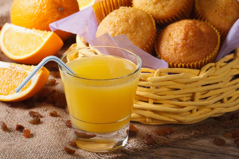 Orange Juice with Muffins Closeup on the Table. Horizontal Stock Image