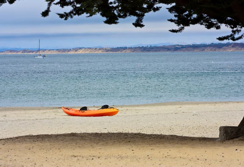 Orange Kayak on a Desert Island Beach. Stock Photo Image of tree