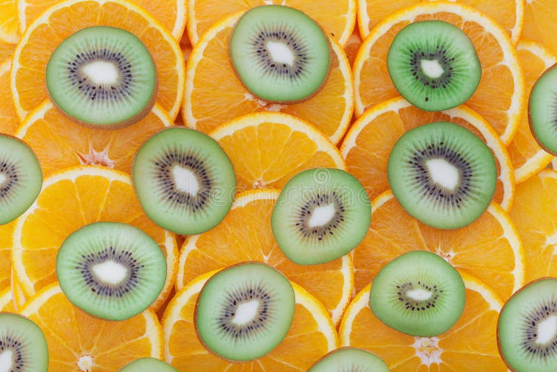 Orange and kiwit rings as background stock photos