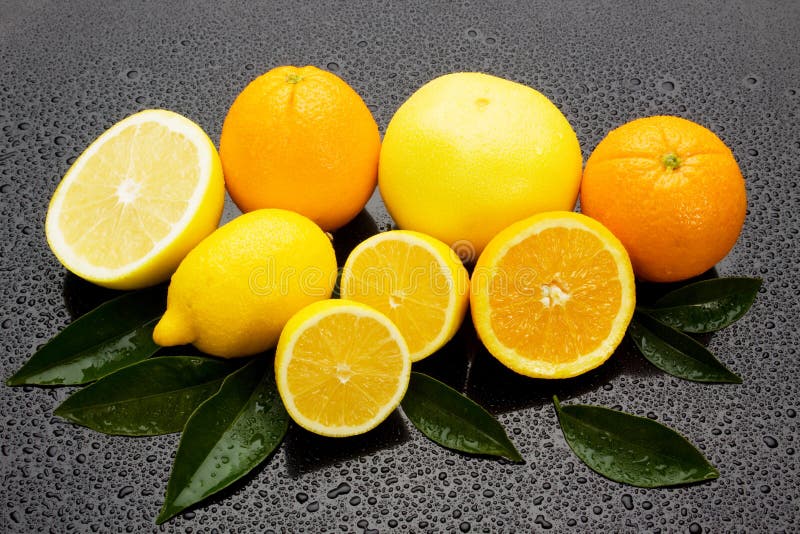 Orange, Lemon and Grapefruit on Wet Surgace Stock Photo Image of
