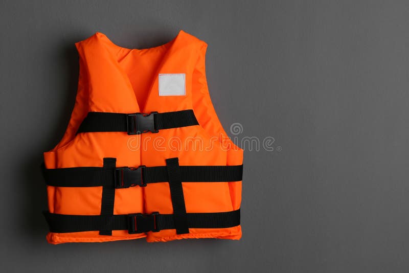 Orange Life Jacket on Grey Background. Space for Text Stock Photo
