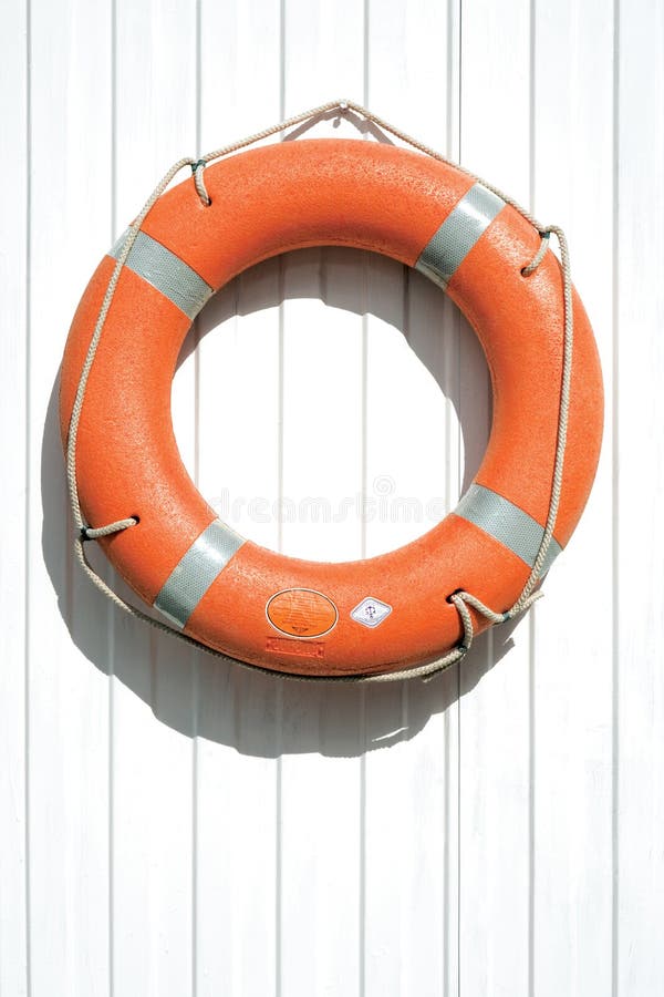 Orange lifebuoy on fence