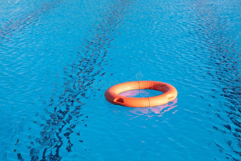 Orange Lifebuoy Floating on a Pool Stock Image - Image of life, round ...