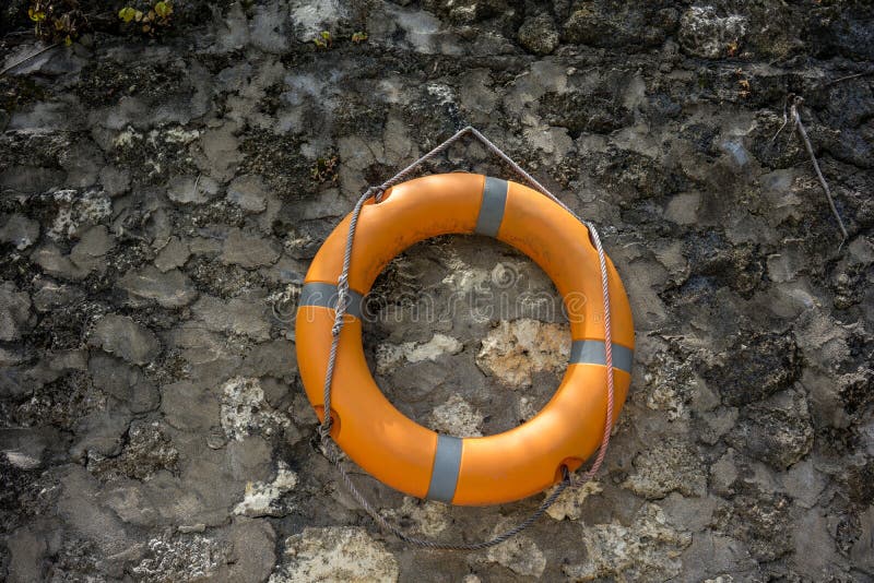 Orange Lifebuoy on vintage concrete wall royalty free stock photo Orange Lifebuoy on vintage concrete wall royalty free stock photo