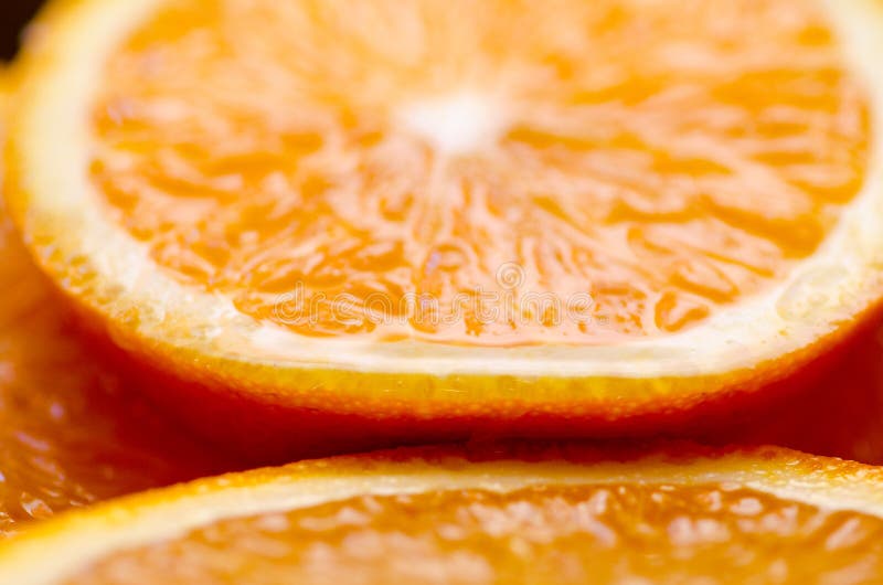 Macro pieces of orange and orange juice