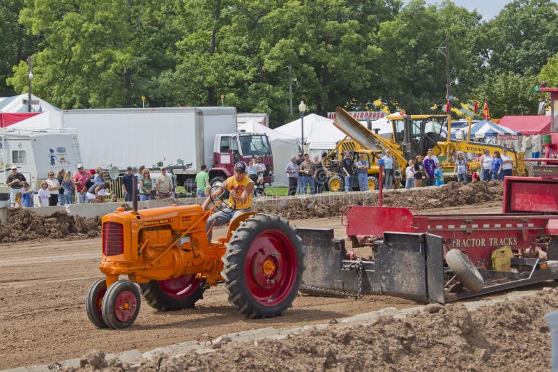 Orange Minneapolis Moline tractor pulling tracks stock photos