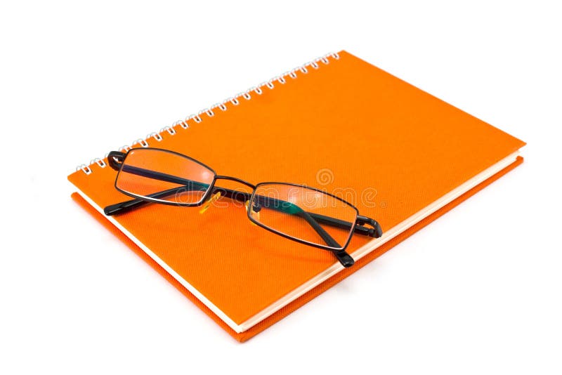 Orange notebook and eyeglasses