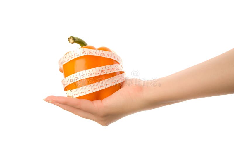 Woman's hand holding orange pepper. Woman's hand holding orange pepper