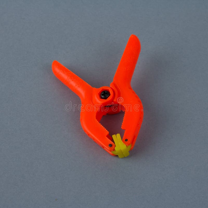 Orange plastic clamp stock image. Image of device, detail 38152811