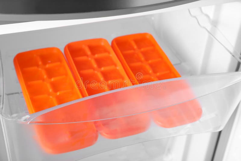 Orange Plastic Ice Cube Trays in Fridge Stock Photo Image of drink