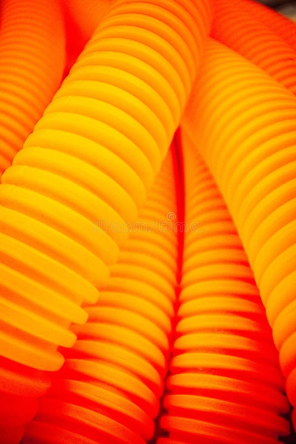 Orange plastic tubes stock photo. Image of detail, plastic 135104394