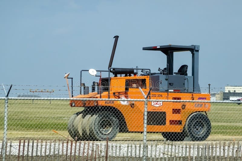 A orange pneumatic wheel roller royalty free stock photos