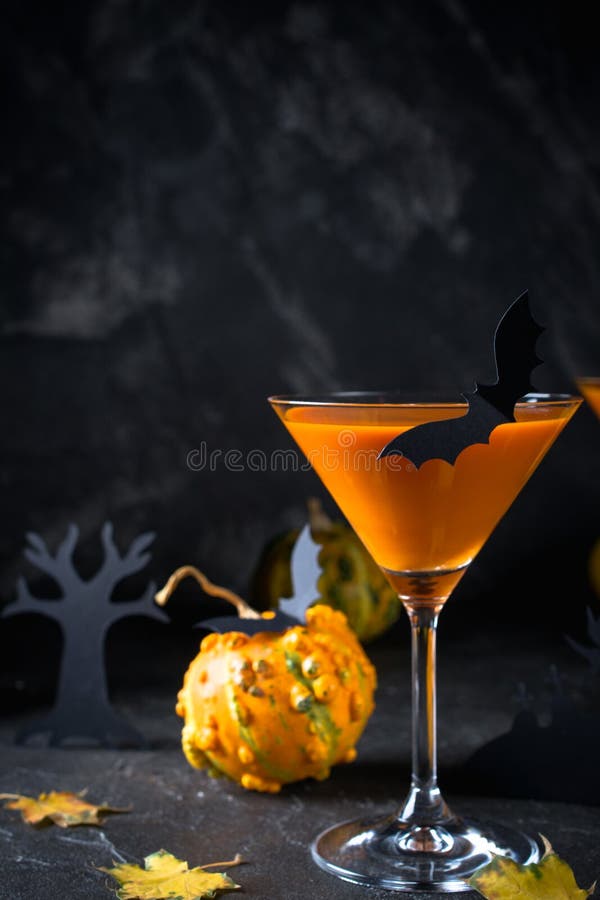 Orange pumpkin, Halloween drink for party and holiday decorations over black  background with copy space