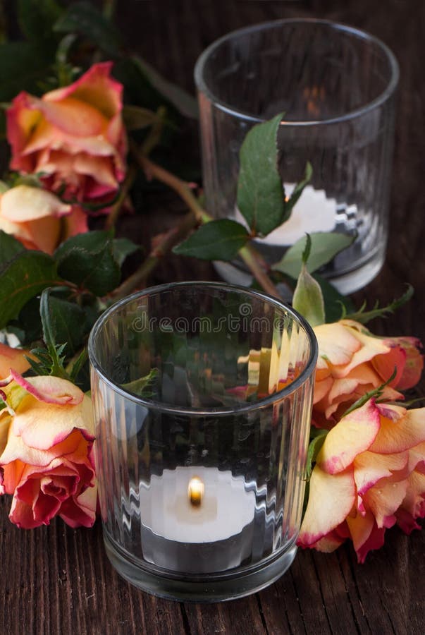 Orange roses with lightning candle