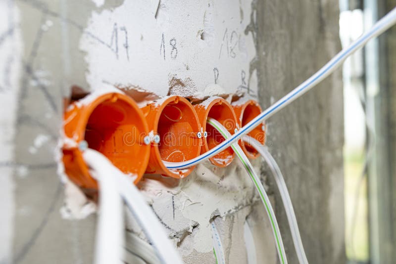 Orange, Round Junction Box Mounted in the White Wall with Protruding