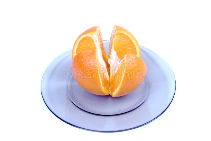 Orange slices. Cut into 4 parts orange, lying on a plate on a white background.