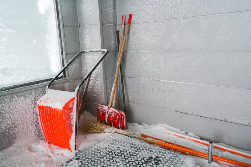 Orange Snow Removal. Shovel in Snow . Stock Photo Image of driveway