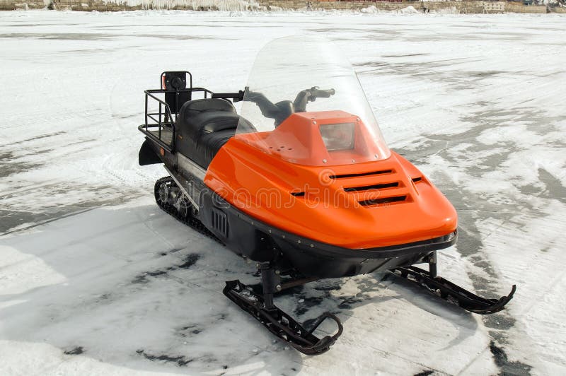 Orange snowmobile on ice