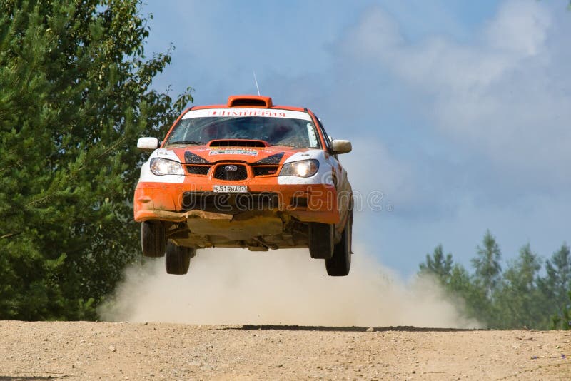 Orange sport car Subaru Impreza jumps at rally