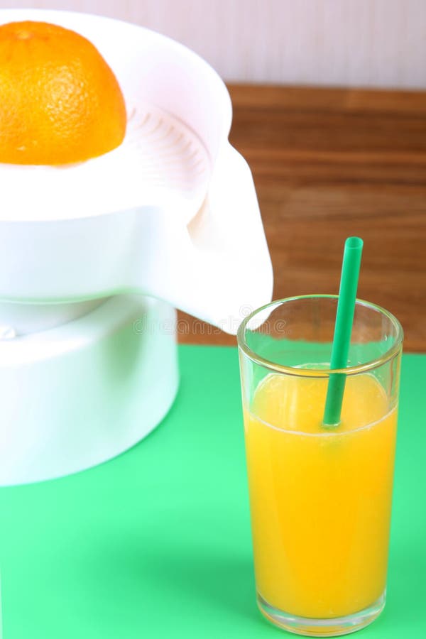Orange on Squeezer, Juicer and Glass of Orange Juice Stock Image