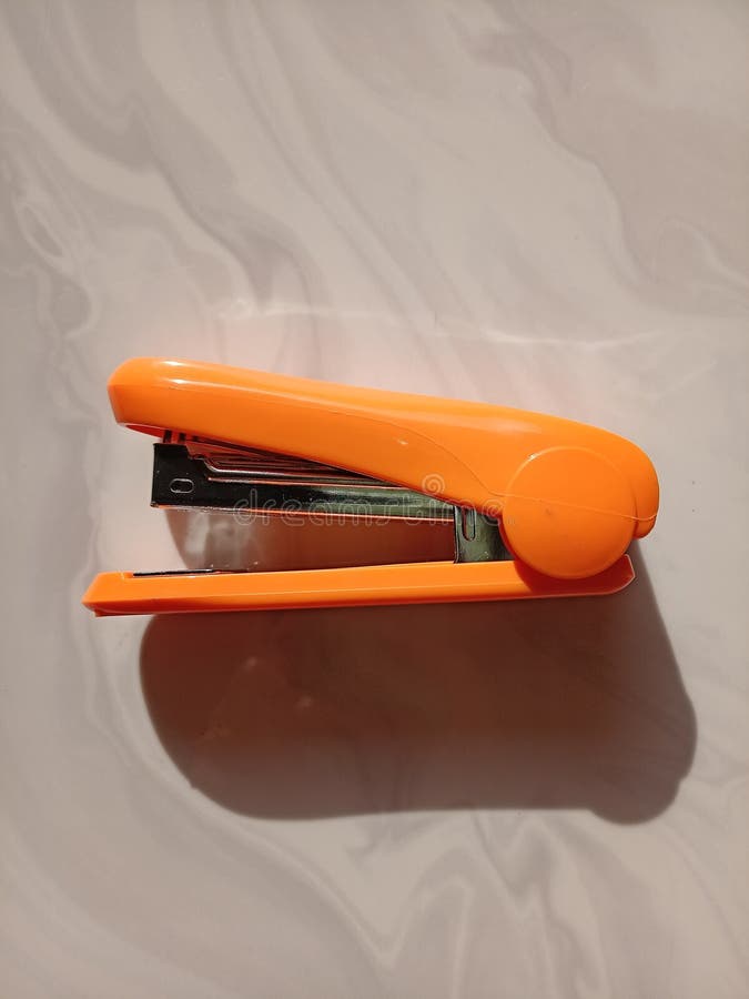 An Orange Stapler, Taken at 90 Degree Stock Photo Image of font