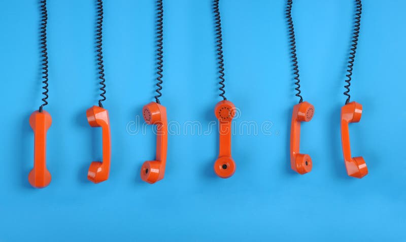 Orange telephones over blue background