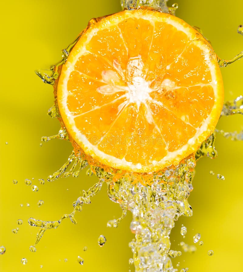 Orange in Water on a Yellow Background Background Stock Image Image
