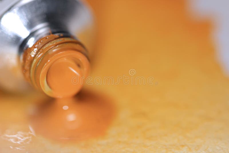 Orange Watercolor paint tube on hand painted background