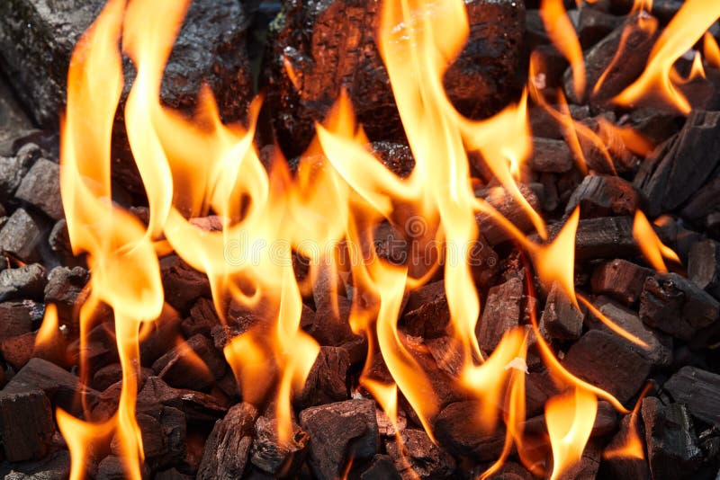 Orange Wild Fire on Black Coal Prepared for Barbecue Grill Stock Photo