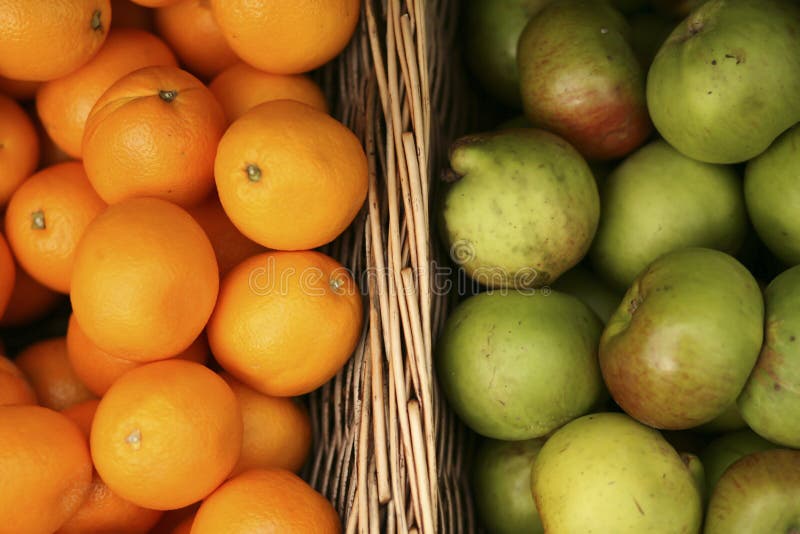 Baskets of delicious, organic apples and oranges at a farmers market. Baskets of delicious, organic apples and oranges at a farmers market.