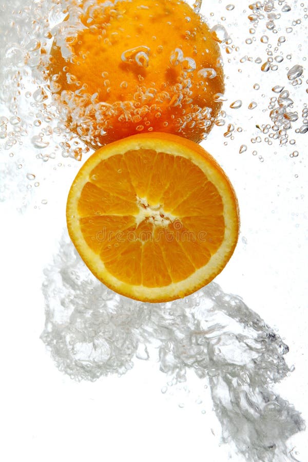 Oranges dropped into water stock photo. Image of fall 17835048