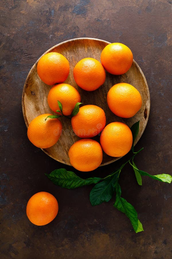 Oranges with leaves on dark background