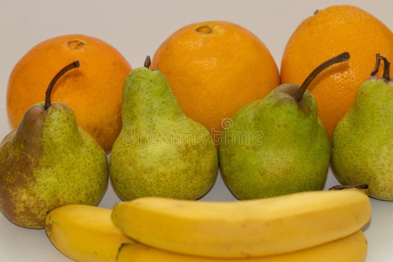 Oranges, Pears and Bananas on a White Isolated Background Stock Photo