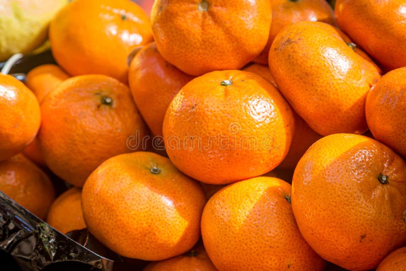 Abundance of Oranges Displayed Flowing from a Bucket on Sale Stock