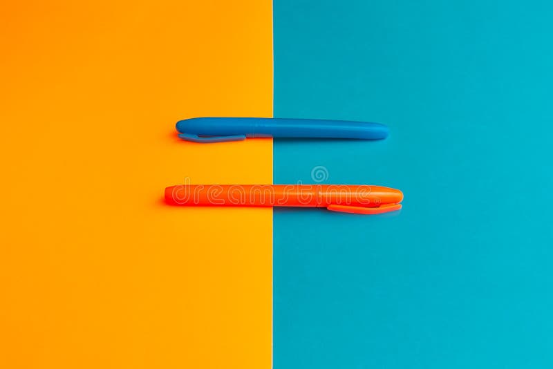 Orange and blue highlighters at cyan blue orange and magenta background with copy space banner advertisement. Orange and blue highlighters at cyan blue orange and magenta background with copy space banner advertisement