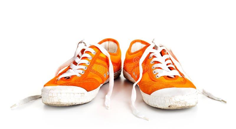 Orange dirty shoes isolated on white background. Orange dirty shoes isolated on white background